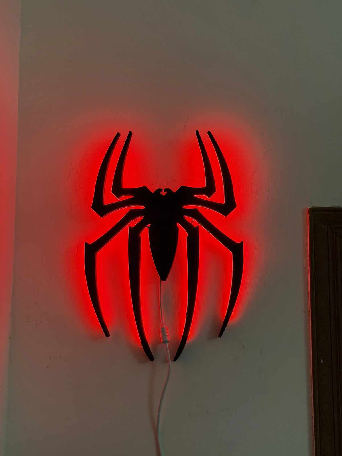 Black Spider Logo LED wall decoration by Evertrend, illuminated black spider design for wall decor, image showing the lit-up LED light.