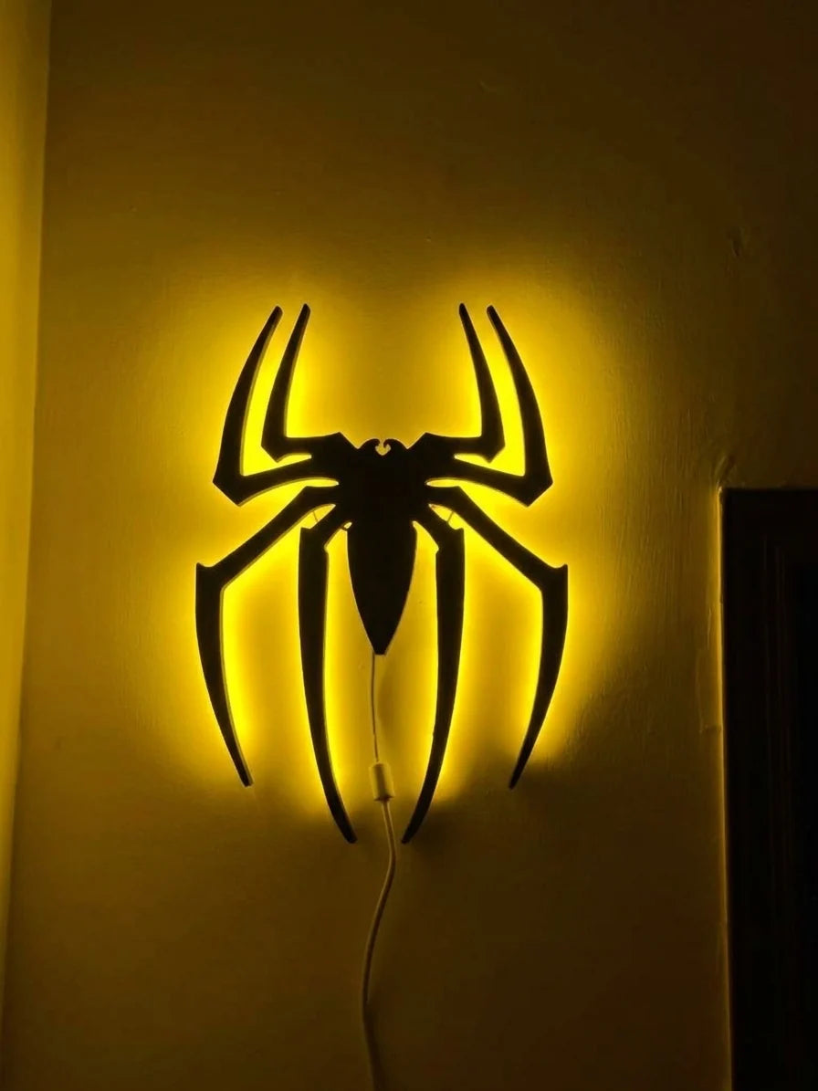 Black spider logo LED wall decoration by Evertrend, illuminated yellow spider design for wall decor.